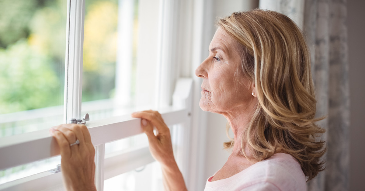 Older woman looking out of the window