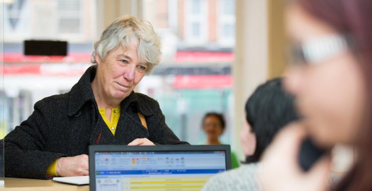 Woman at a GP reception desk