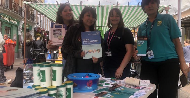Members from Healthwatch, Dartford Gravesham & Swanley CCG and One You Kent  standing at their stall on Dartford Market Street