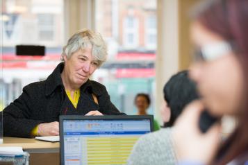 Woman at a GP reception desk