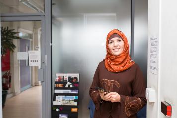 Woman smiling with phone in hand