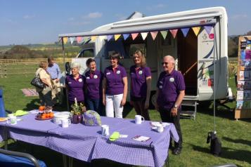 Volunteers of Rural Kent Coffee Caravan Project standing infront of their van.