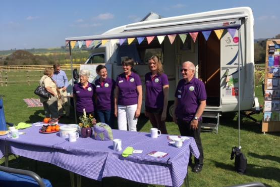 Volunteers of Rural Kent Coffee Caravan Project standing infront of their van.