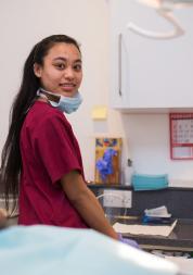 Dentistry nurse smiling while the patient is sitting patiently. 